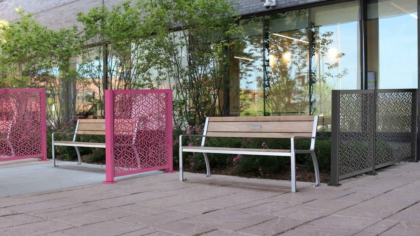 970 backed benches and Flexx panels in front of building with trees