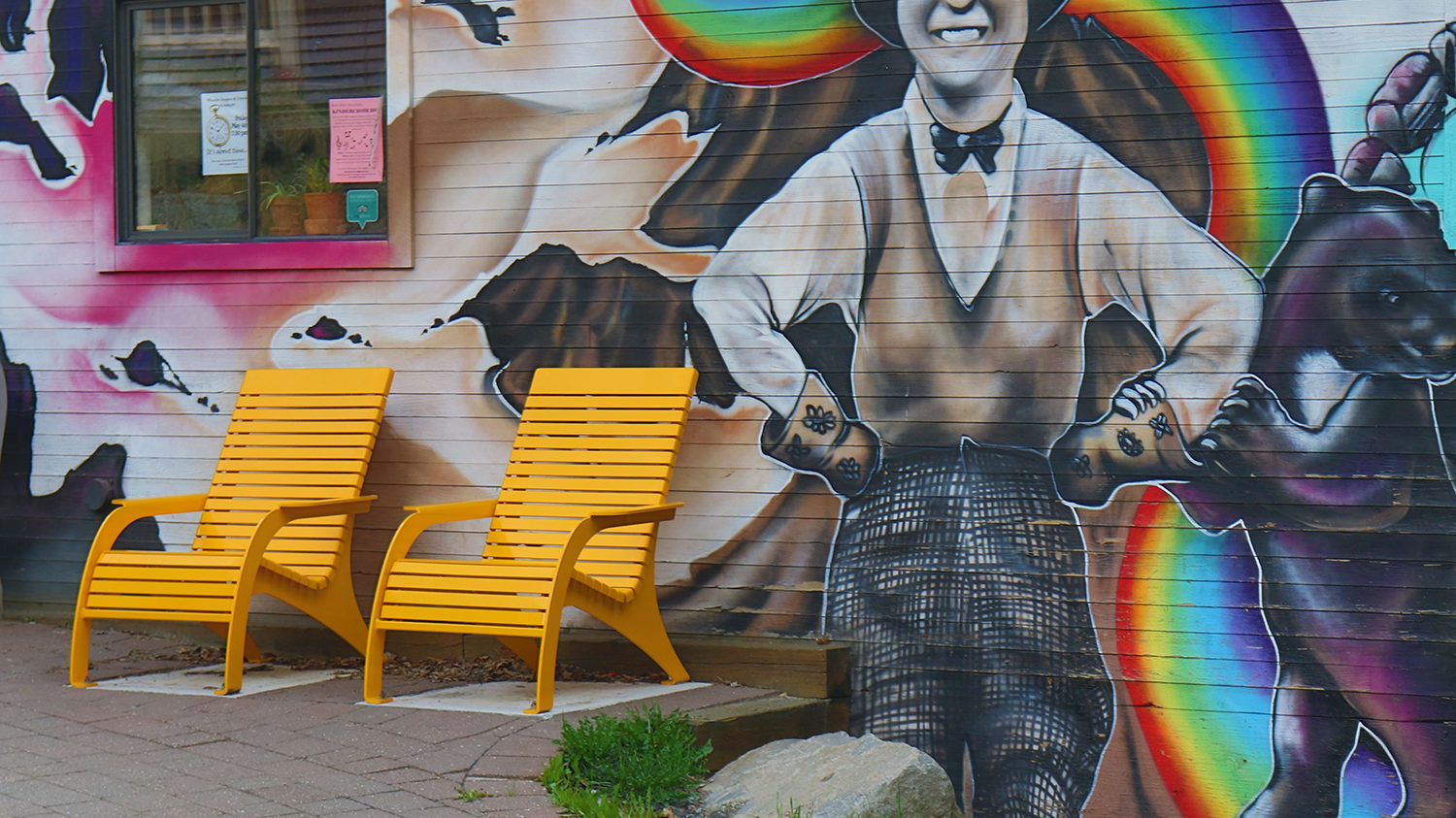 Yellow 720 Whistler Chairs next to painted building