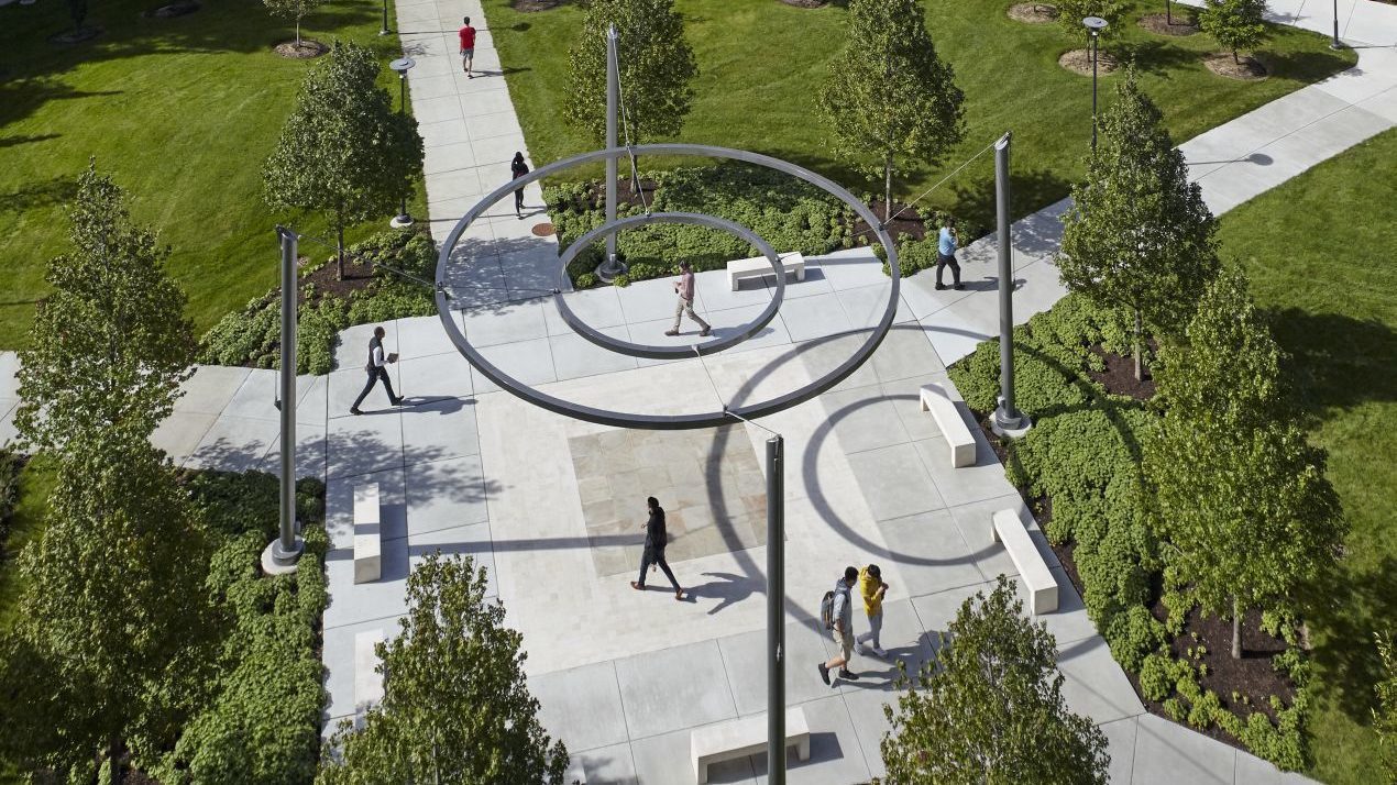 Overhead shot of two circles suspended in air with students walking beneath