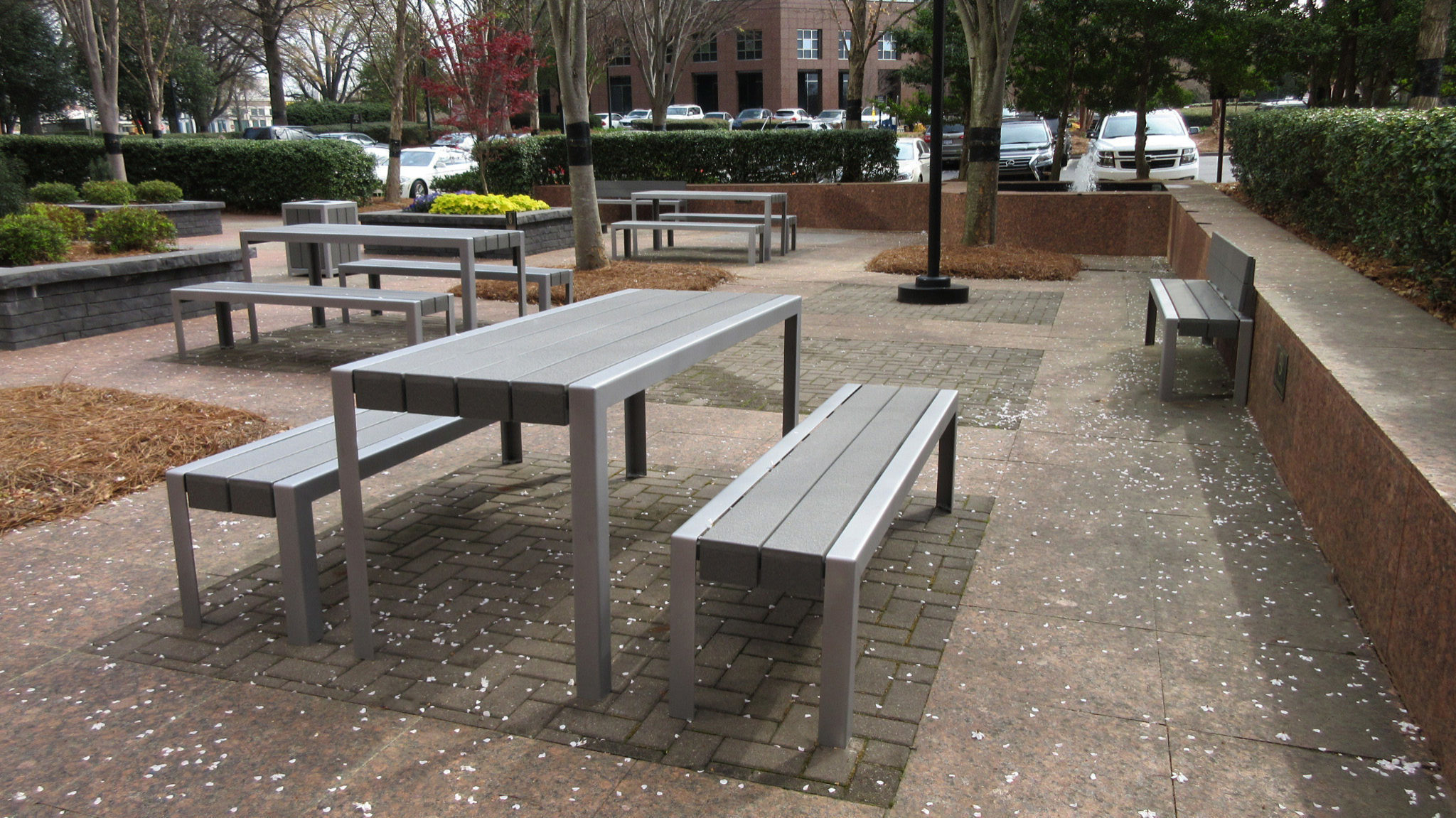 Grey and silver tables and benches in courtyard