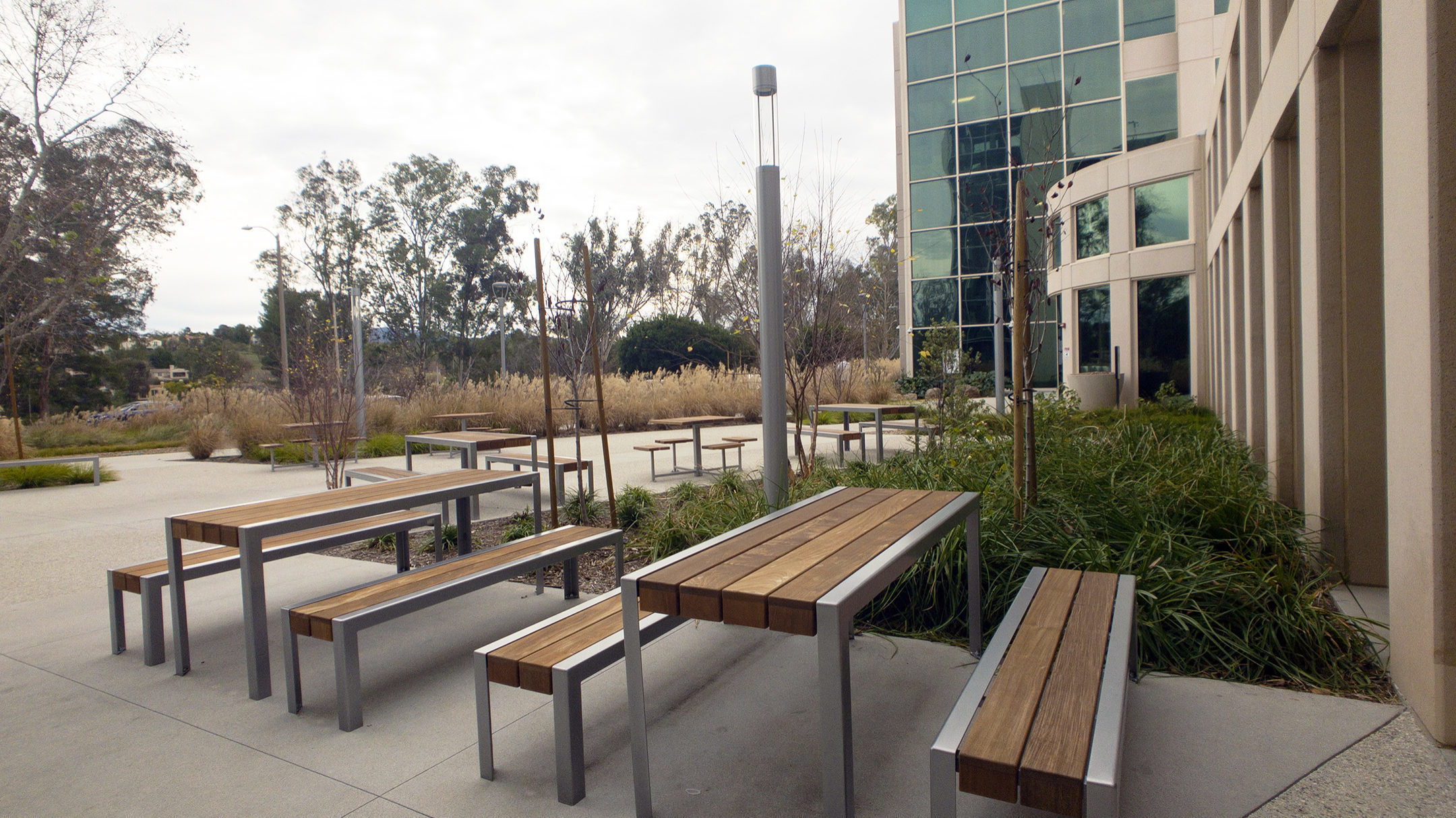 1050 wood tables and backless benches in courtyard