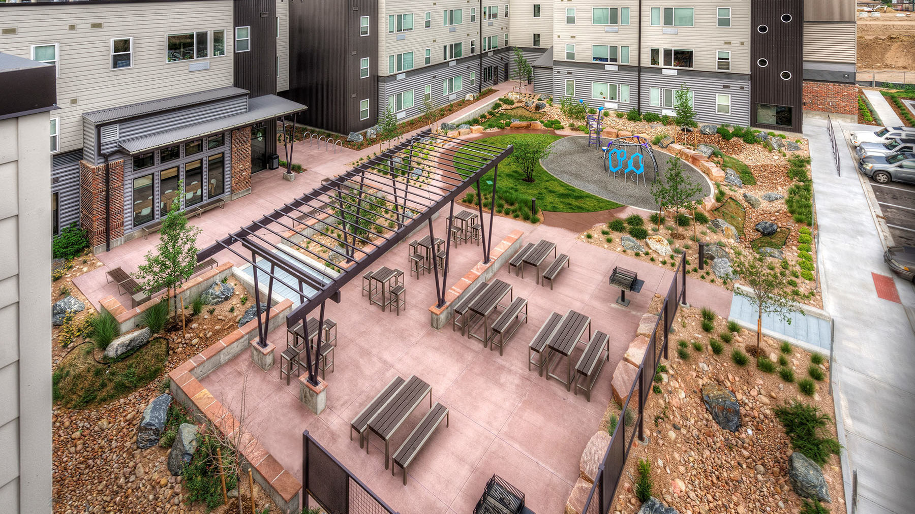 Apartment courtyard from above with picnic tables and landscaping