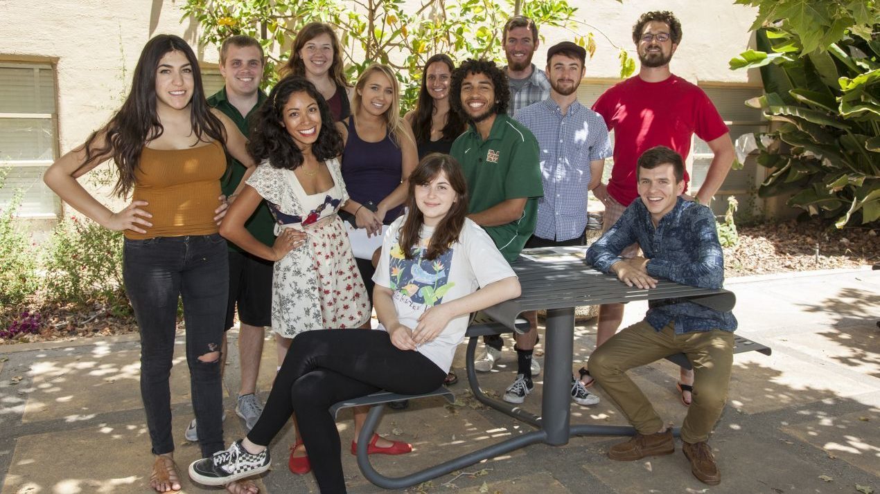 Students at CalPoly University sitting on grey table and chairs