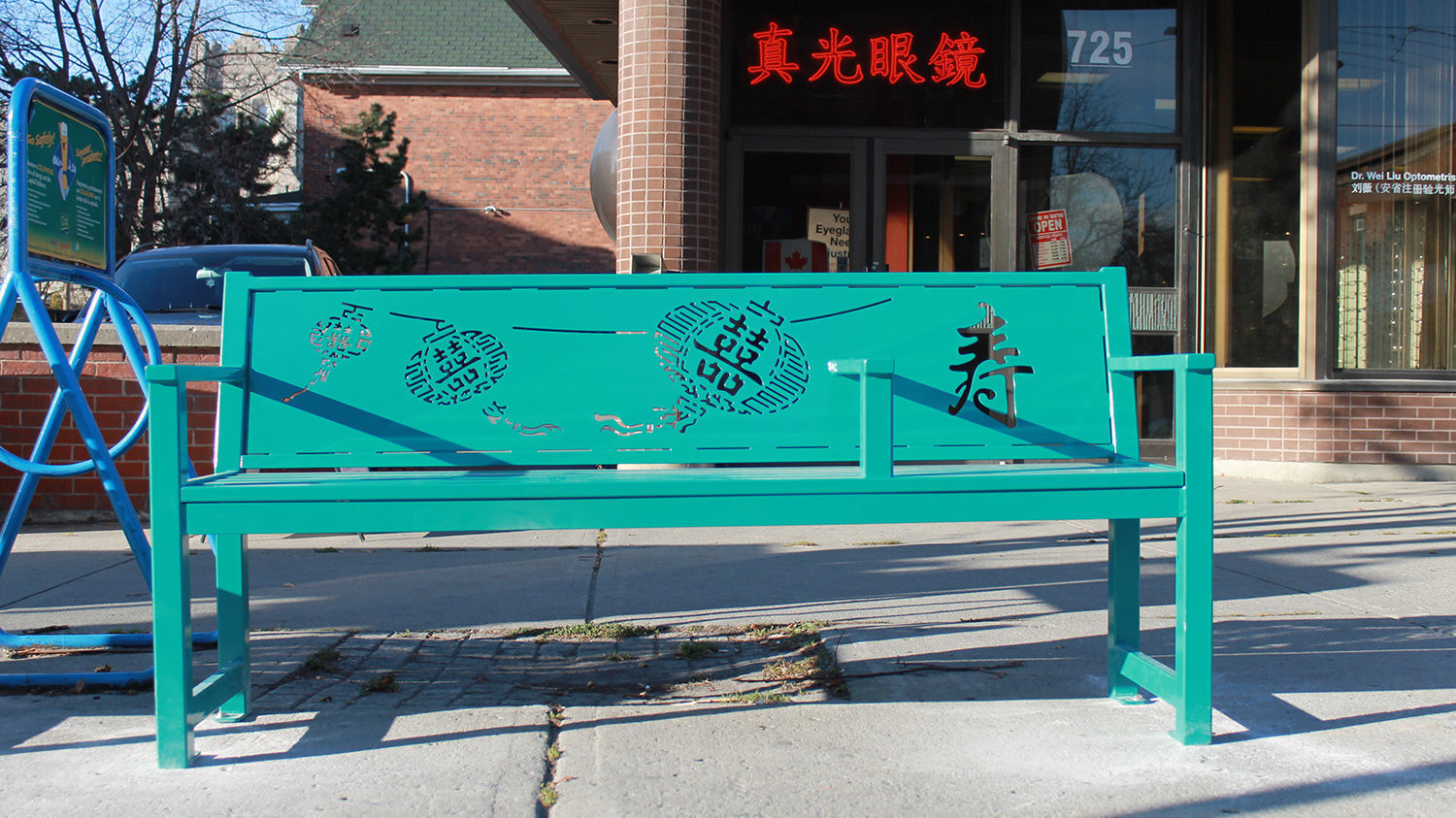 Turquoise bench with lasercut Chinese symbols in China town