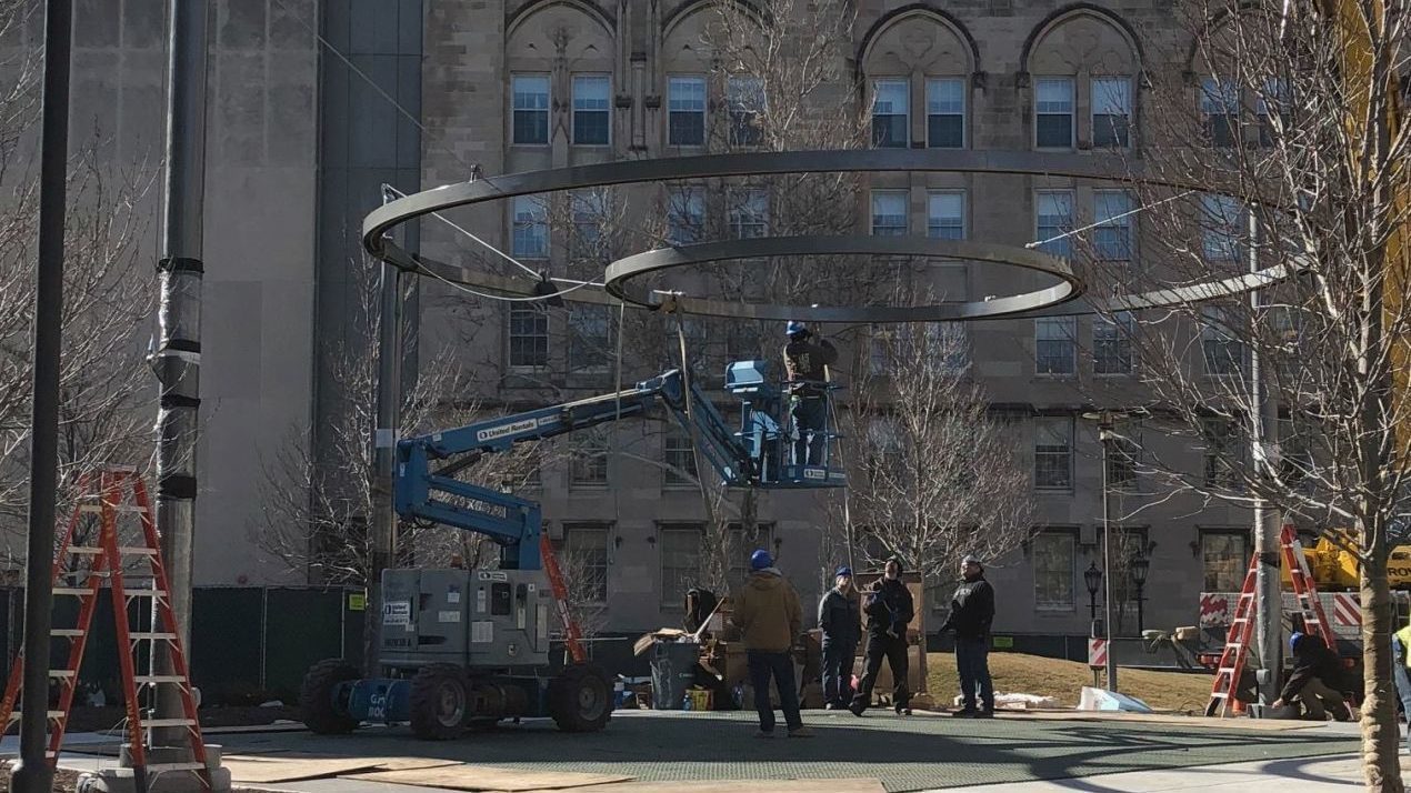 Construction workers suspending two circles in the air