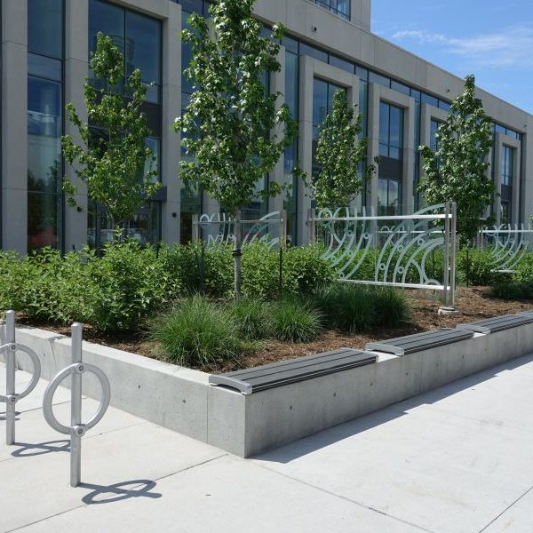 Outside of a building featuring bike racks, garden decor, and backless benches