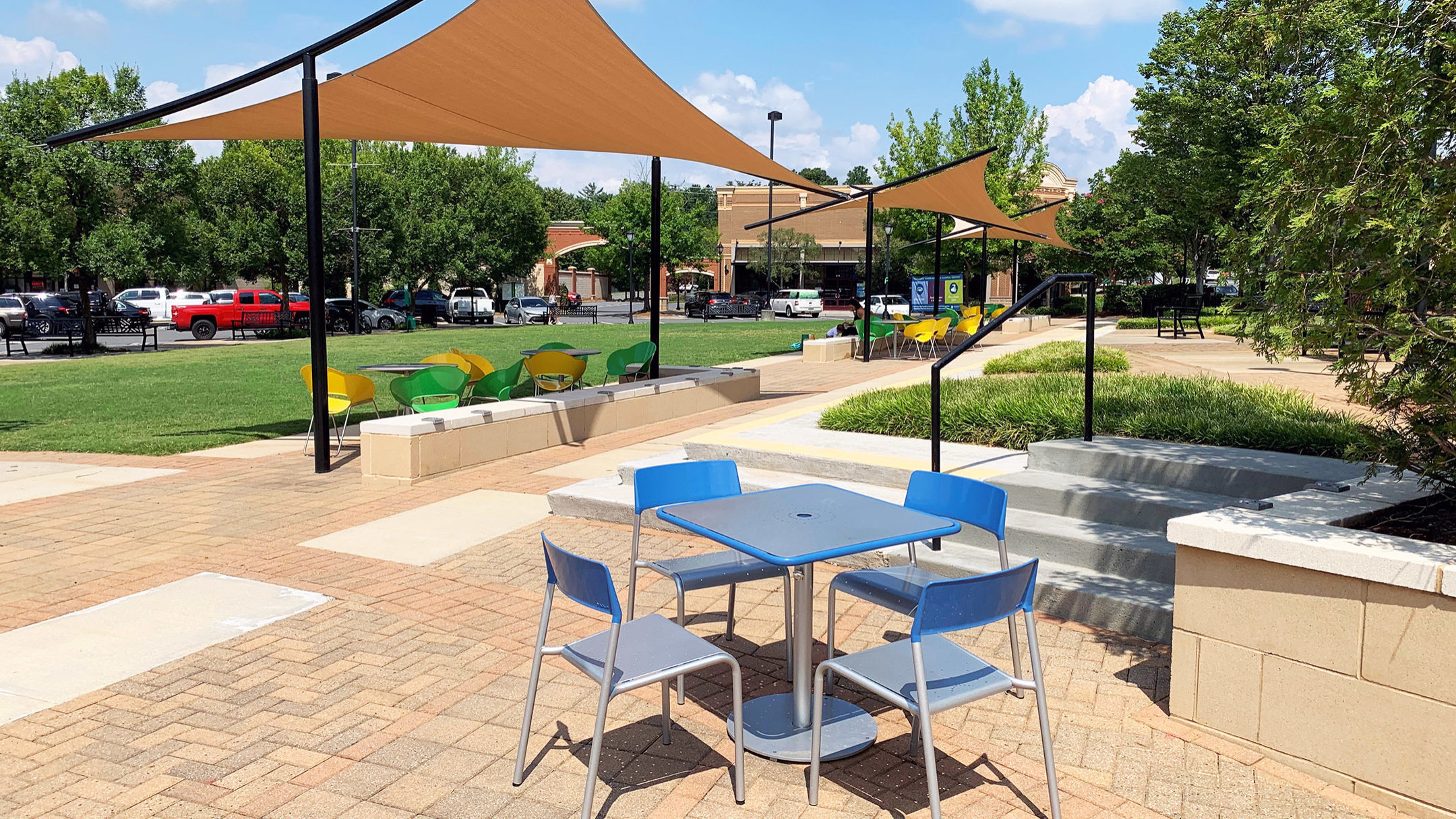 Set of Blue and silver Foro Table and chairs in a town square