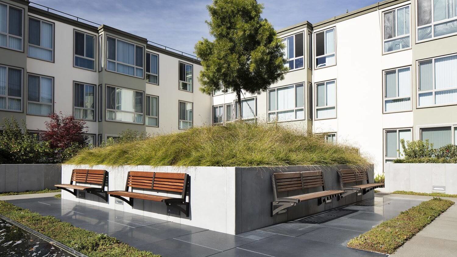 Backed Benches attached to Concrete Near Apartment Complex