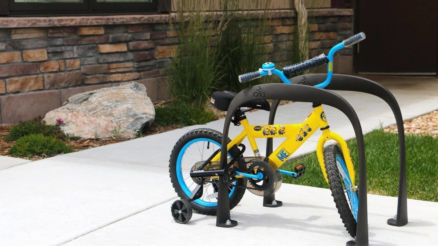 Yellow childrens bike on bike rack