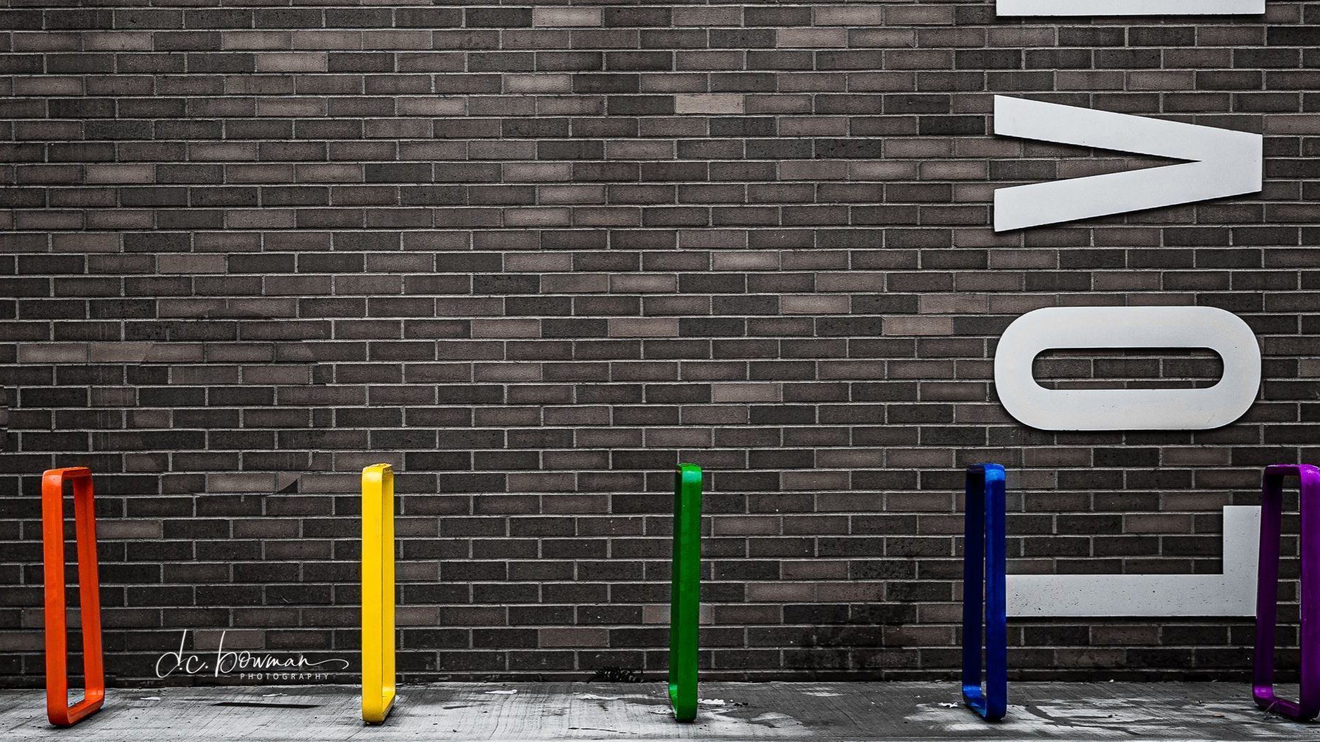 Brightly painted Iconic Bike Racks in front of LOVE wall