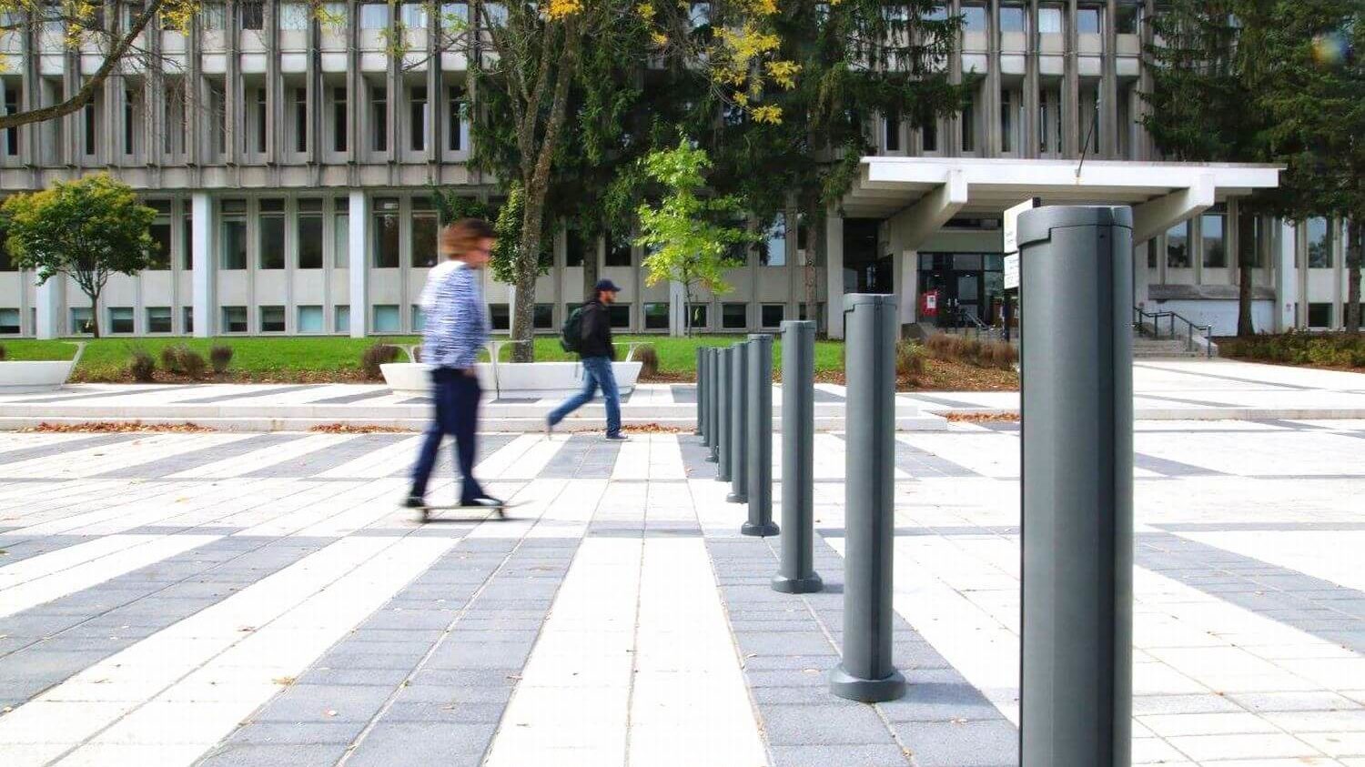 Bollards outside Laval University with man walking