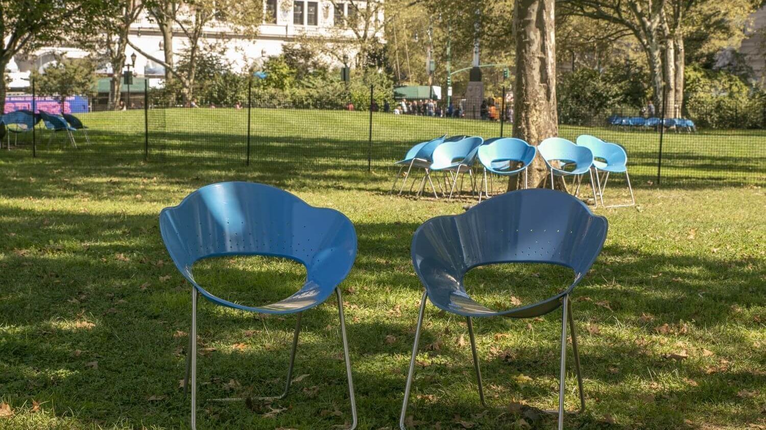 Two blue chairs in a park