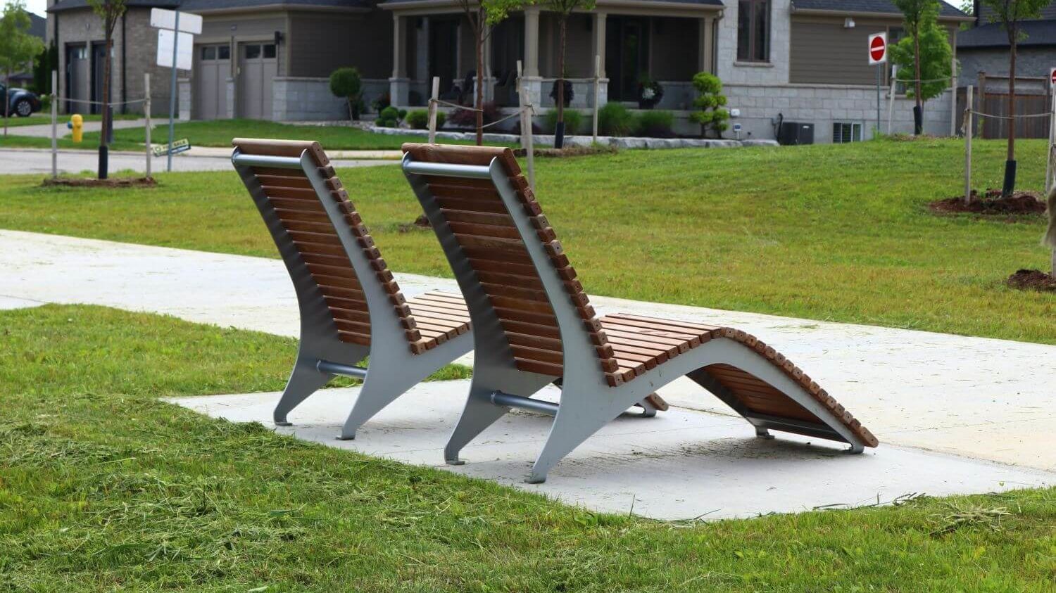 Two wood and metal chairs facing away from the camera