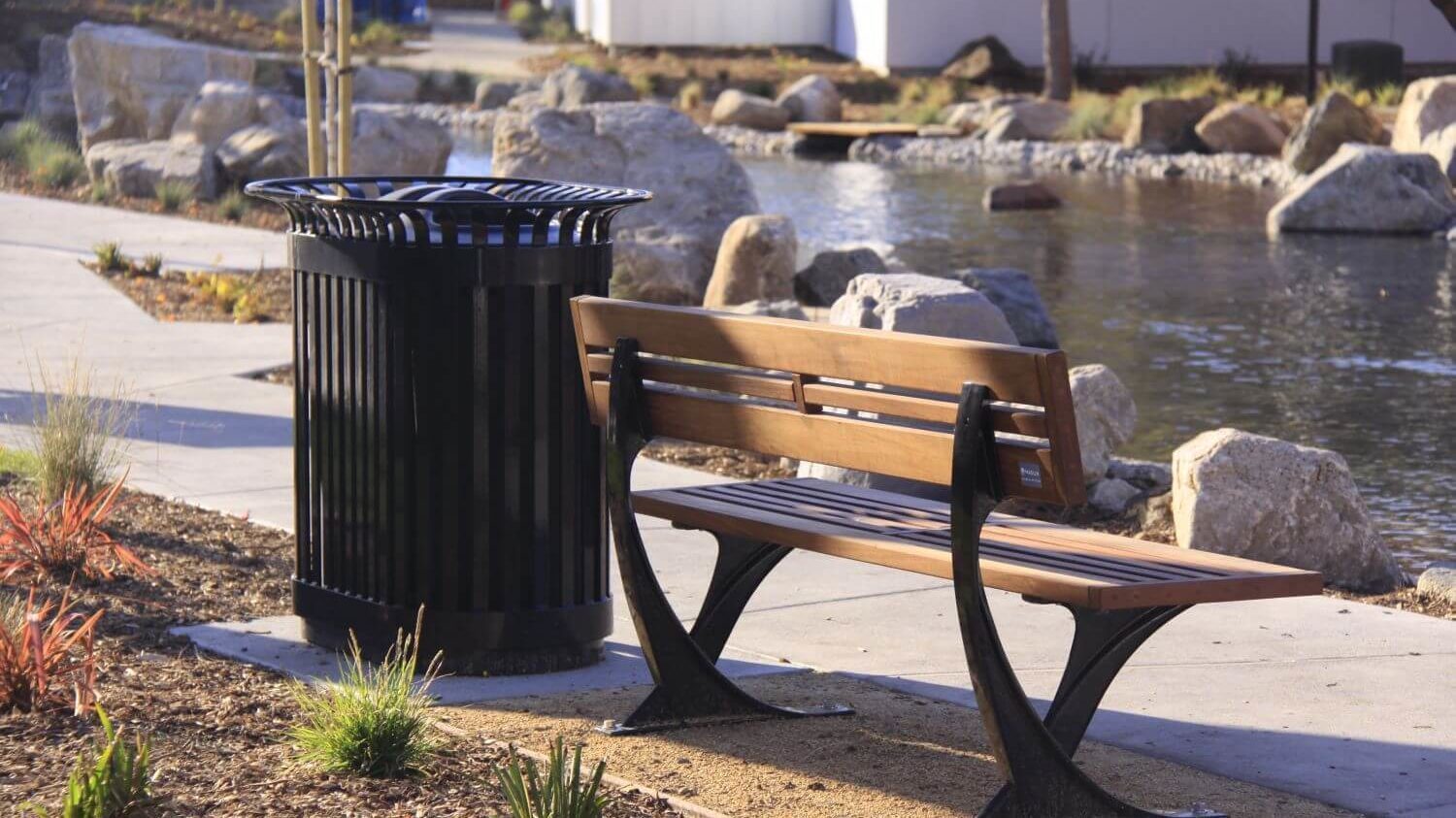 Wooden Bench and Black Bin