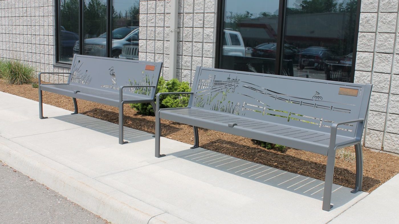 Two metal benches with designs carved in