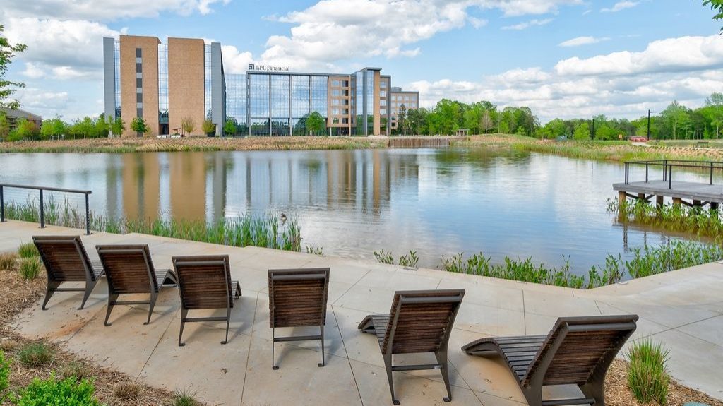 720 wood chaise lounge overlooking pond at Kingsley Town Center