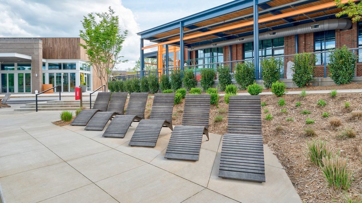 720 wood chaise lounge in a row with building behind