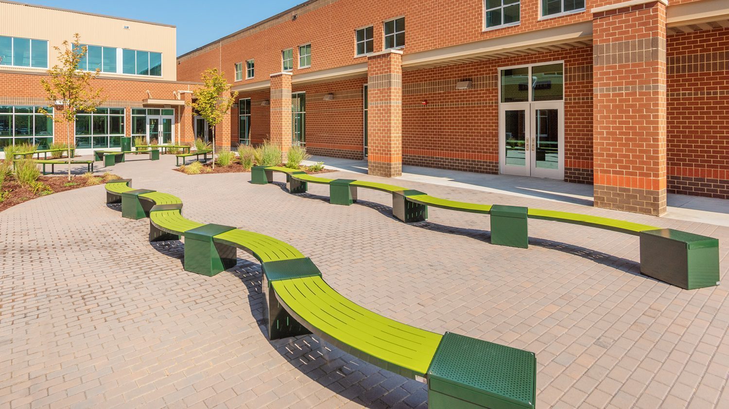 Green Lexicon seats with square modules in school yard