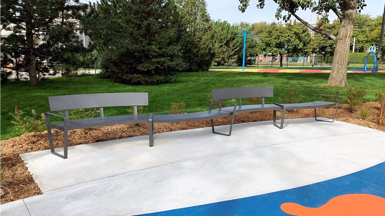 Curvy Lexicon Benches with and without backs in park setting