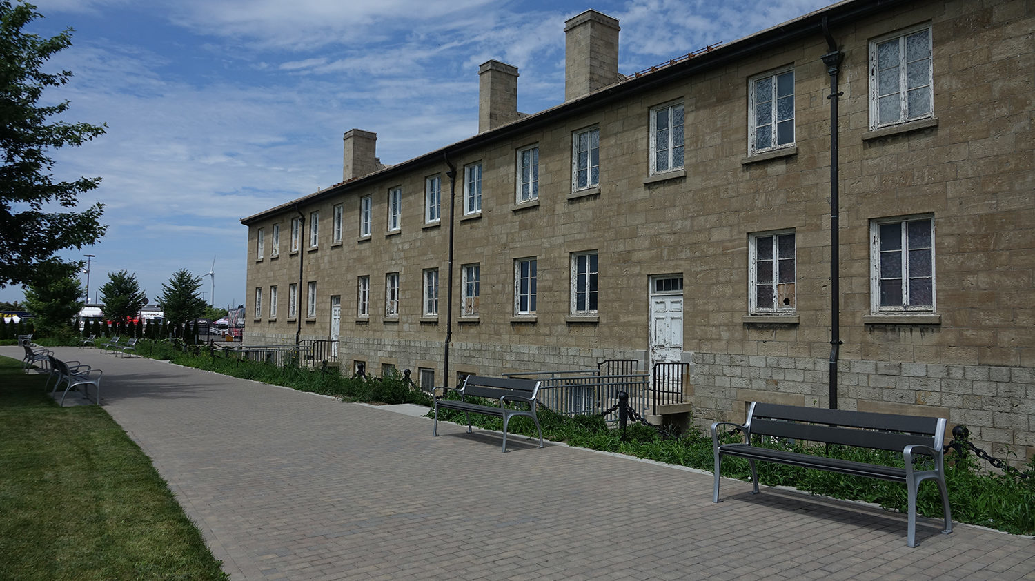 870 Backed Benches in front of brown building