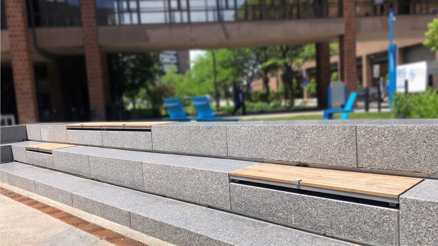 Wall-mount Ogden seats with Thermally Modified Ash Wood in university courtyard