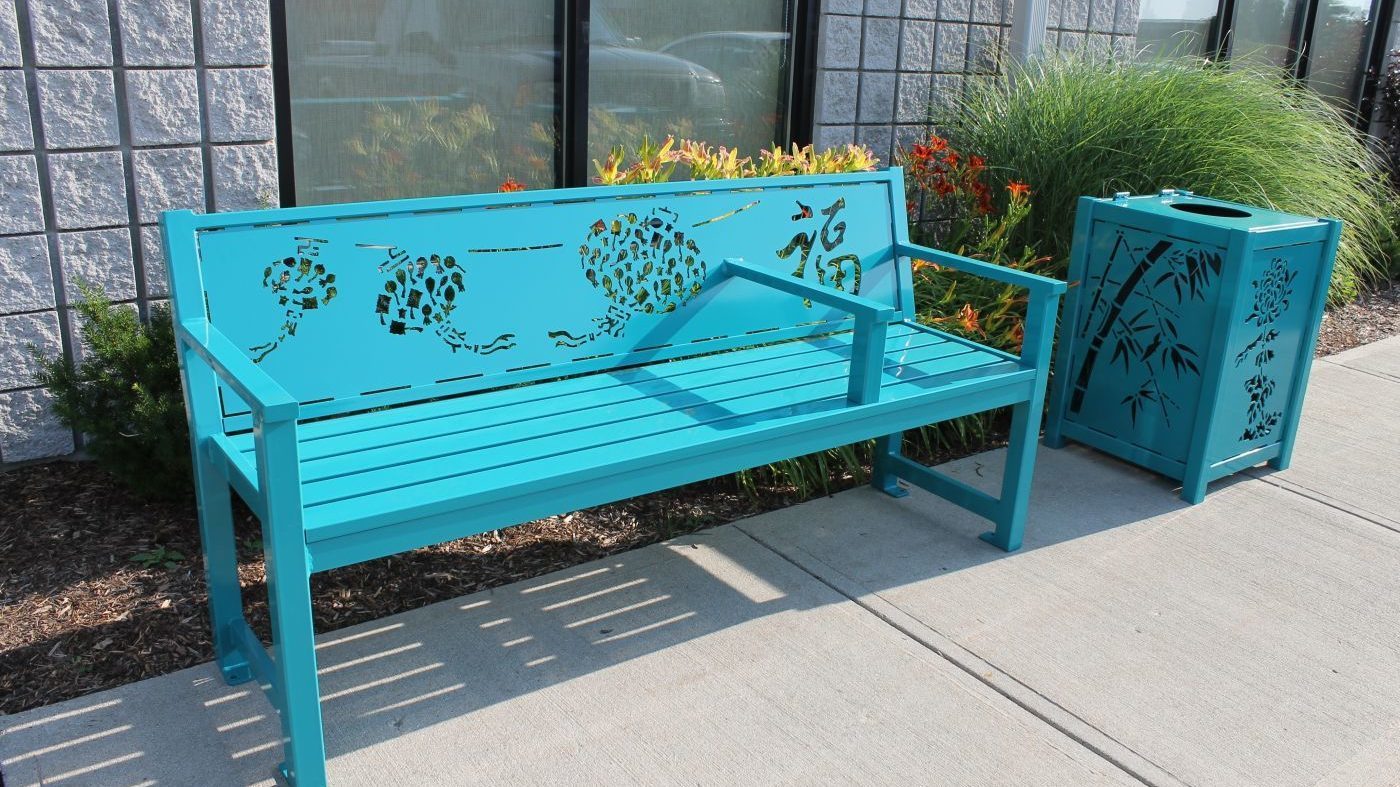 Blue Bench with Design and Trash Can