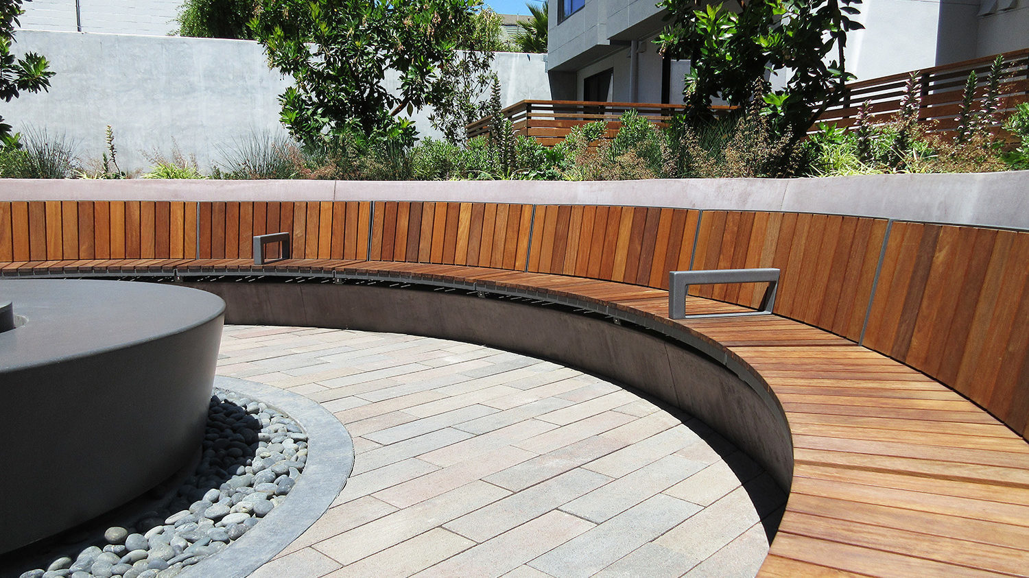 Curved wall-mounted Ogden surrounding fire pit