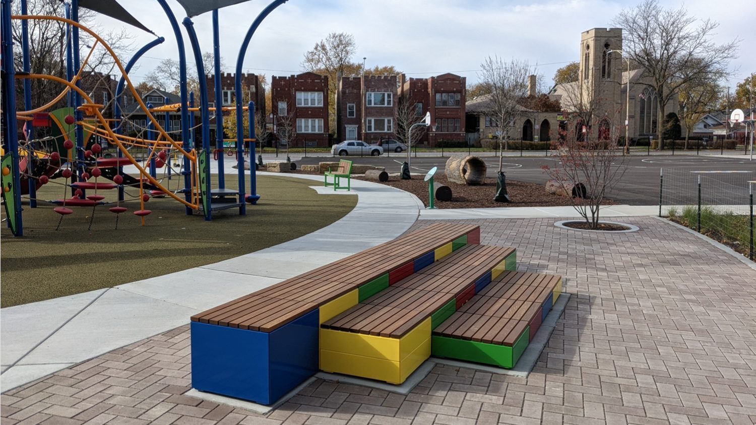 Brightly painted Pixel blocks stacked next to playground