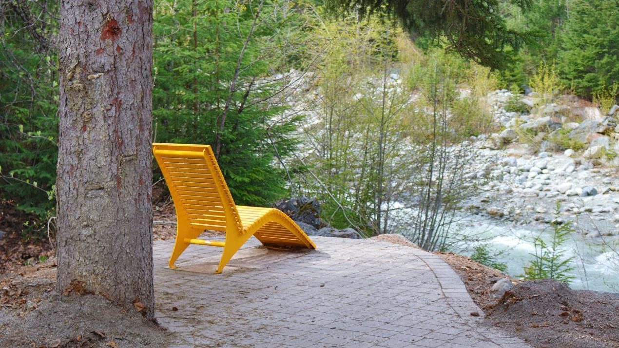 One Yellow Chair facing a river