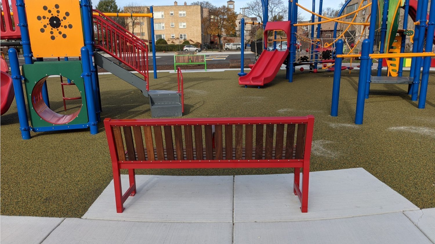 Brightly painted 400 series benches at school playground