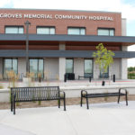 Two Backed and One Backless Bench Outside of Hospital