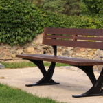 Backed Wood Bench near stone wall