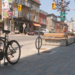 Silver Bike Racks with surface mounts on Downtown Streets