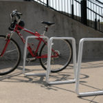 White Bike Rack with Red Bike Leaning on it