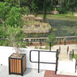 Man Overlooking Garden and Water Area