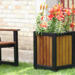 Wood and Black Planter with Orange Flowers