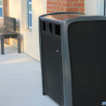 Black and Grey Trash Can Outside Building