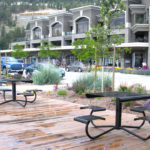 Two Metal Tables on Deck Near Commercial Area