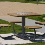 Table with Attached Individual Seating, with a chess board on top at a park