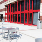 Metal Chairs and Table Outside Red and White Brick Building