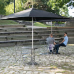 Umbrella, table and chairs outside