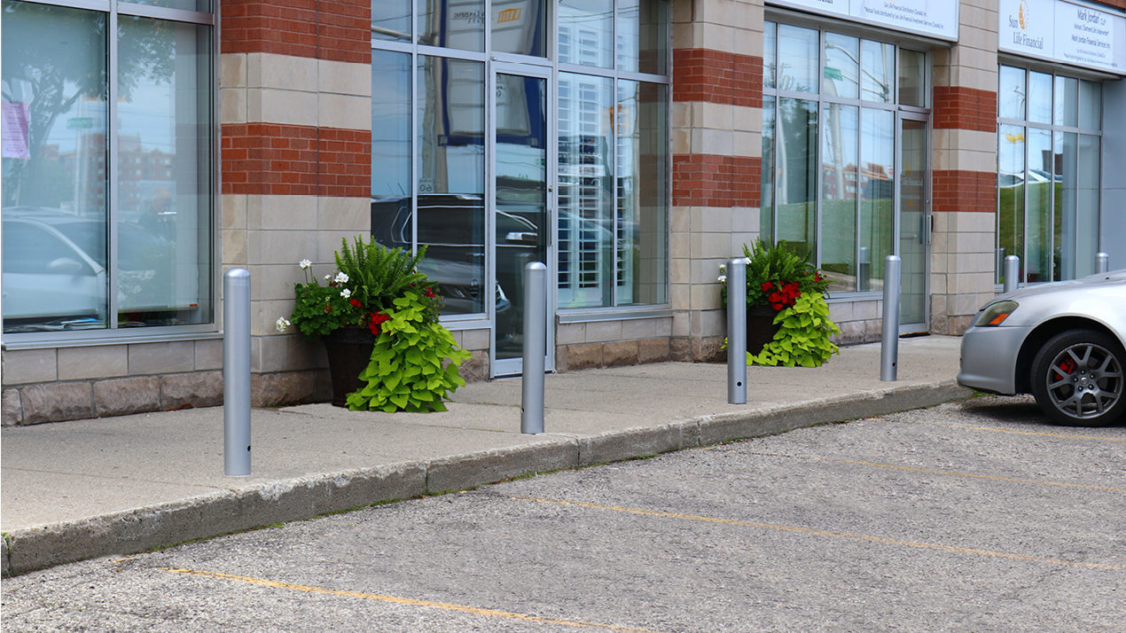 500 Series Bollards painted silver in front of office building