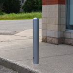 500 series bollard on side walk with vehicle in background