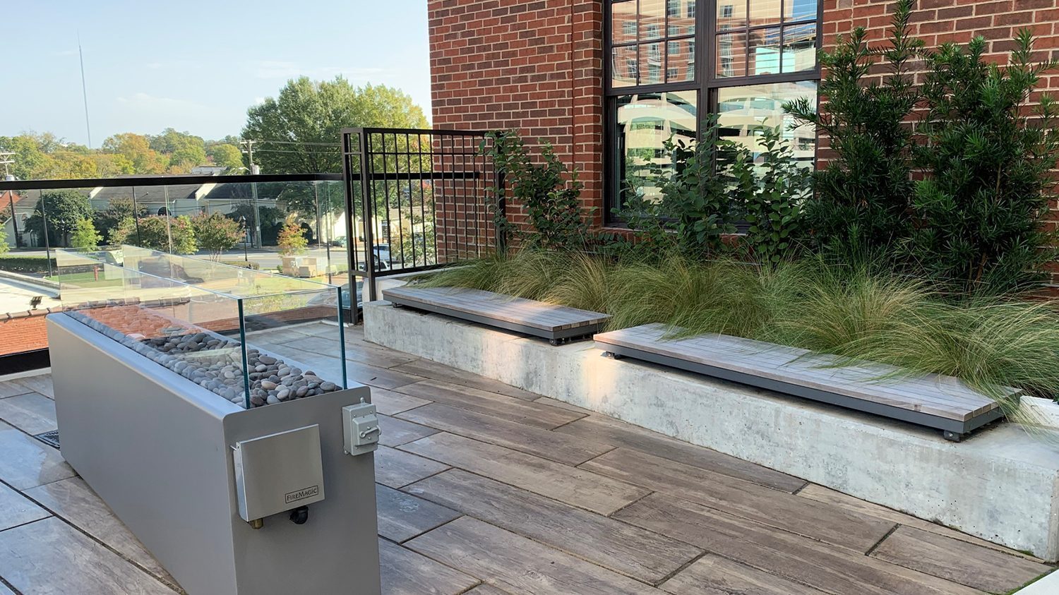 Rooftop patio featuring Ogden straight benches and a fire feature