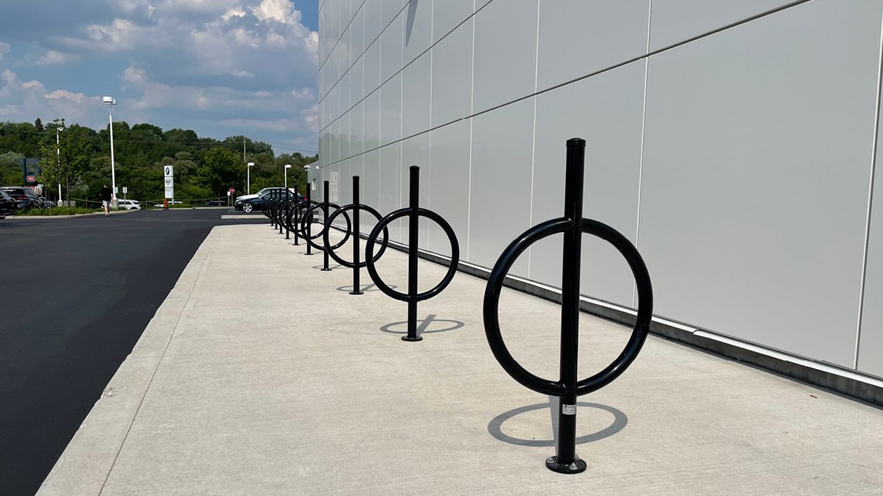 100 Series Bike Rack painted gloss black on sidewalk next to building