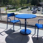 Foro Collection Round Table and Chairs, blue powdercoat on balcony