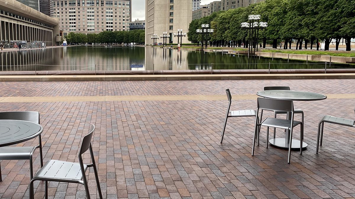 Maglin silver Foro tables and chairs before a large reflecting pool at Christian Science Plaza in Boston