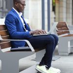 L-Series Backed Benches with handsome man sitting down in city scene