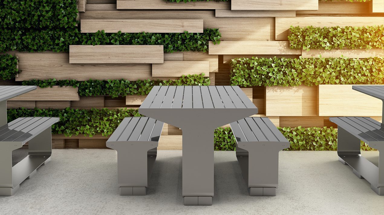 L-Series Tables and Seating next to green planter wall