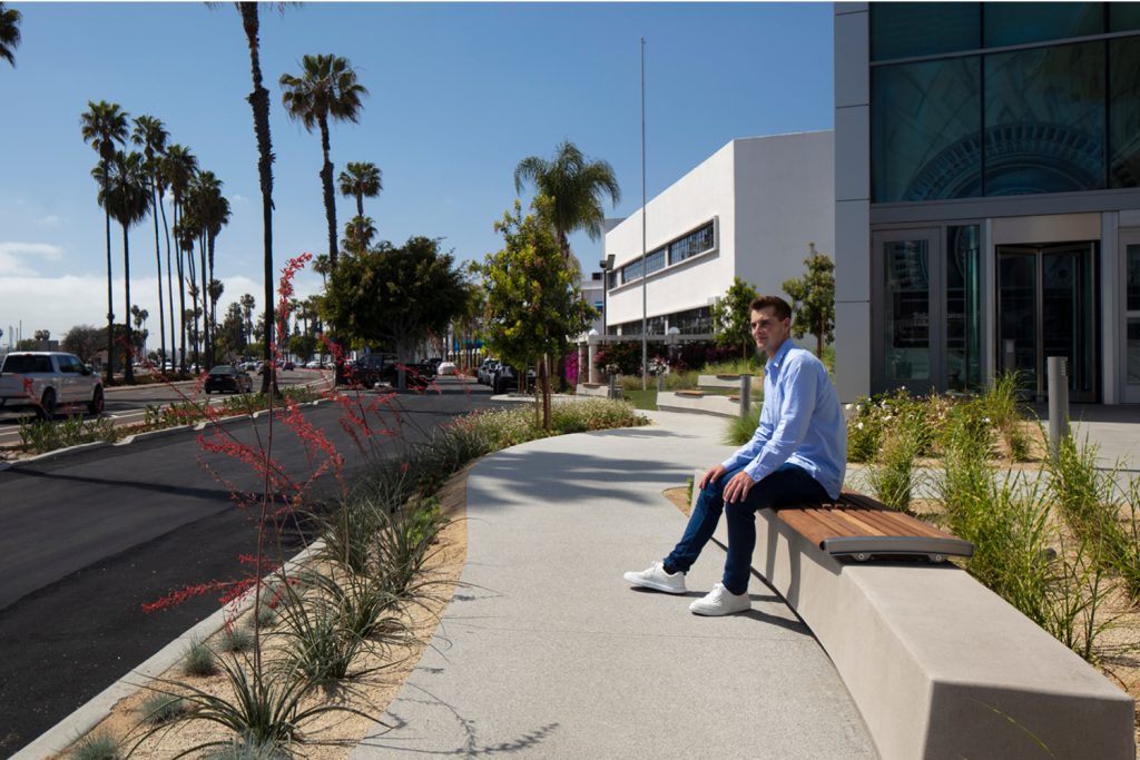 Brad sitting on a Maglin 720 wall mount bench in California